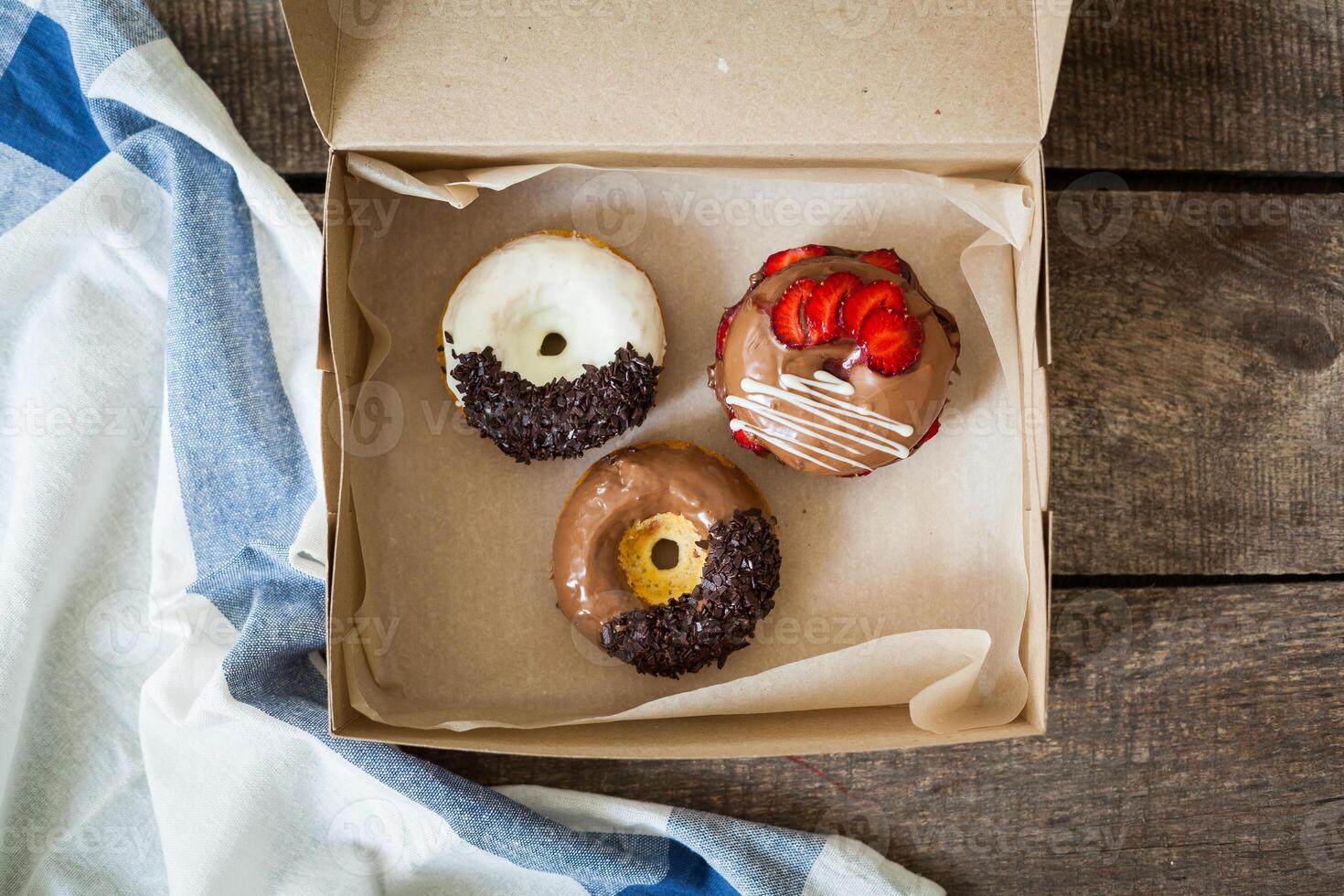 Colorful donuts in box photo
