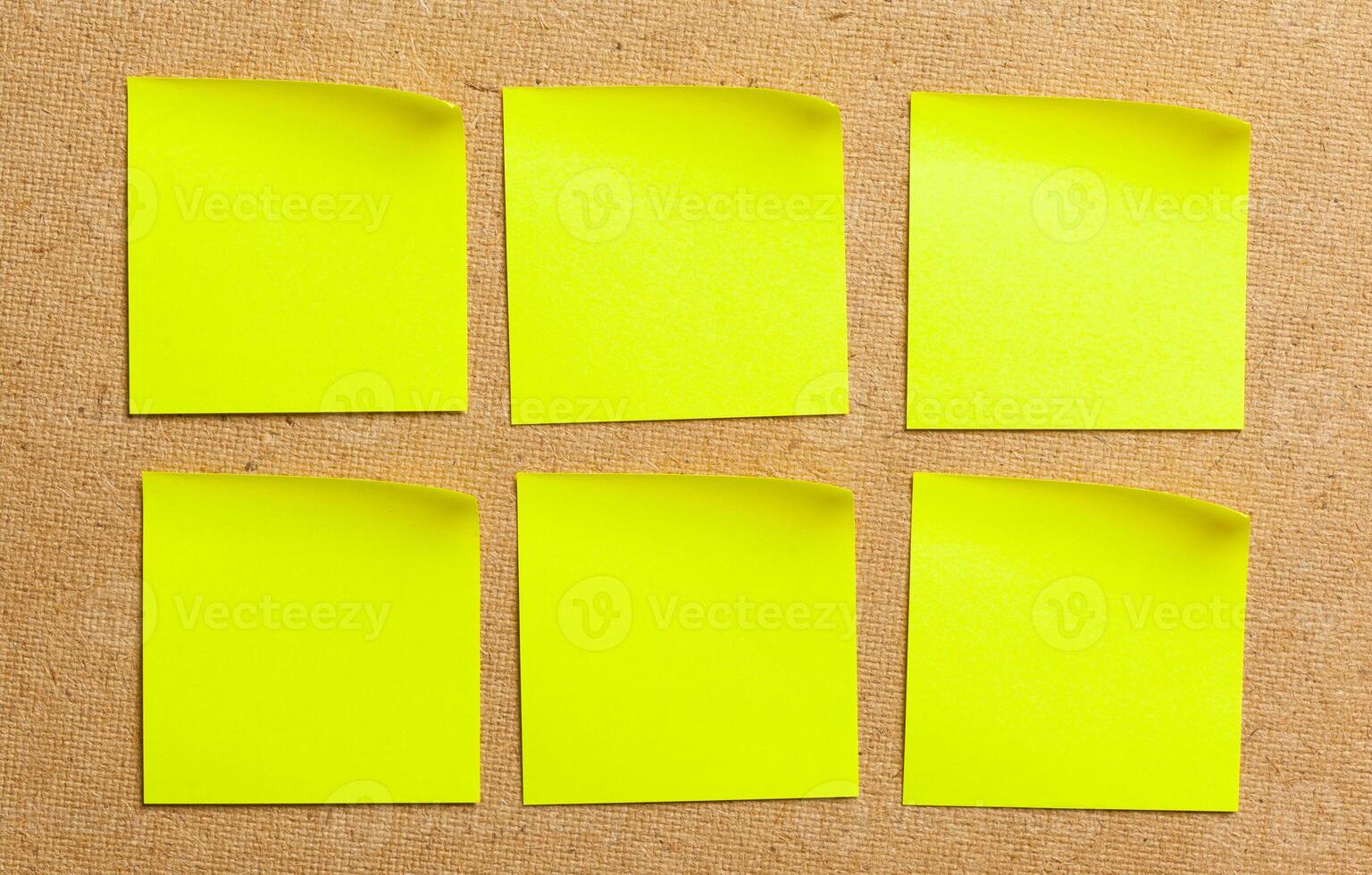 Color sticker notes over cork board background photo