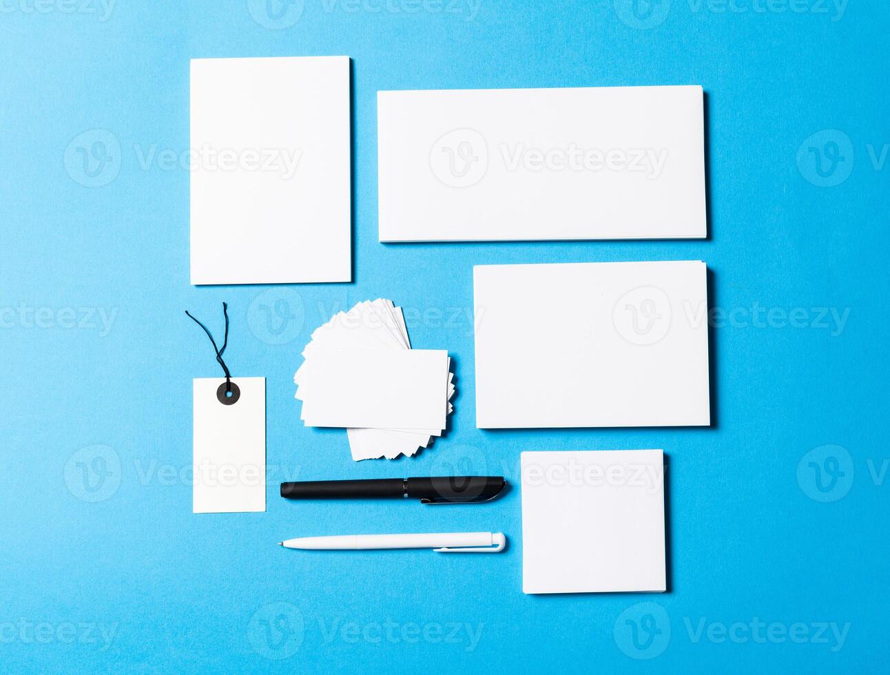 blank office objects organized for company presentation on blue paper background photo