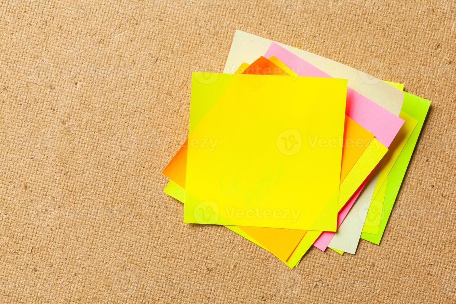 Color sticker notes over cork board background photo