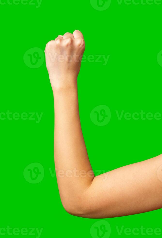 Fist raised in determination against a bright green background showing strength and motivation photo
