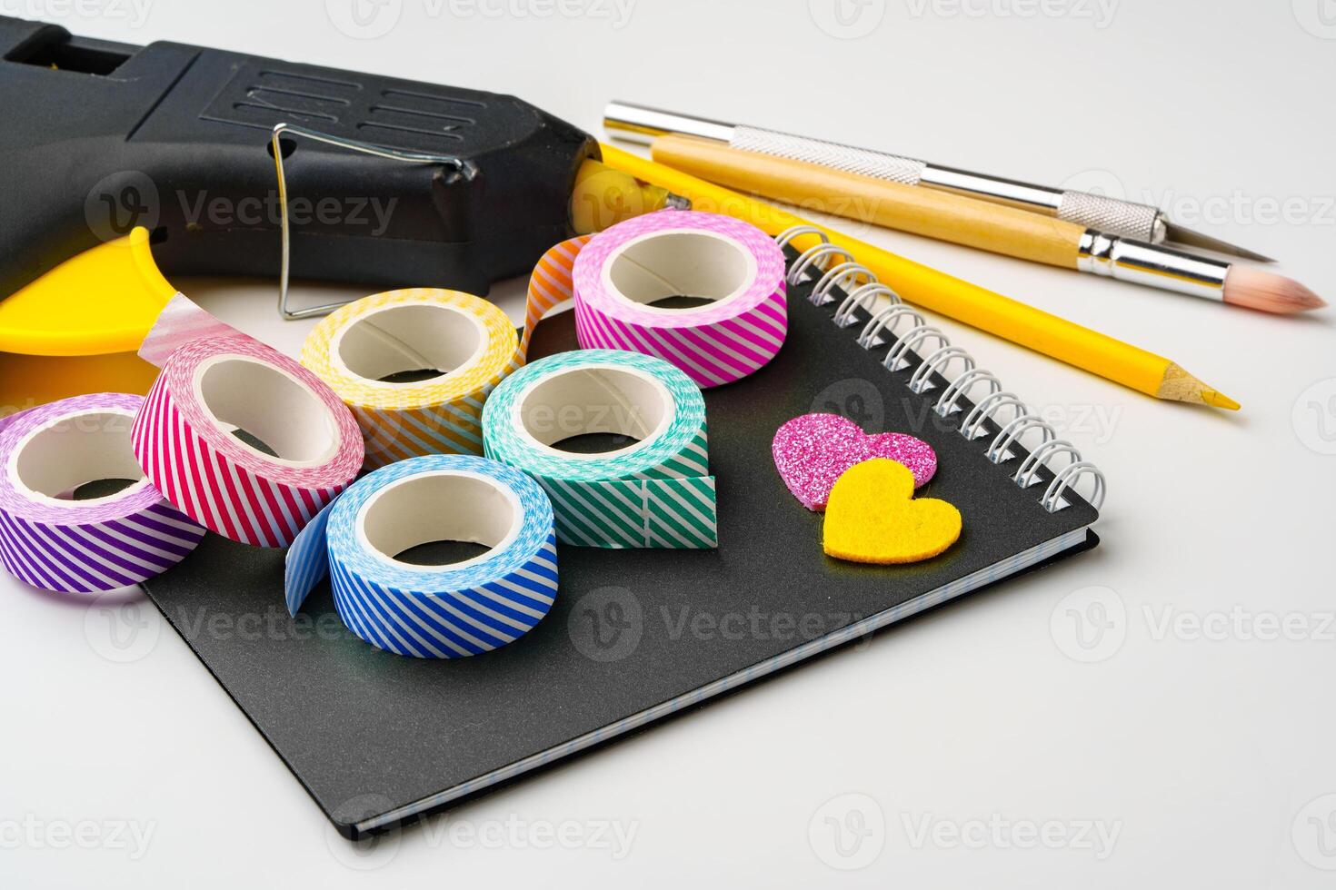 Crafting supplies neatly arranged with colorful tapes and tools on a workspace photo