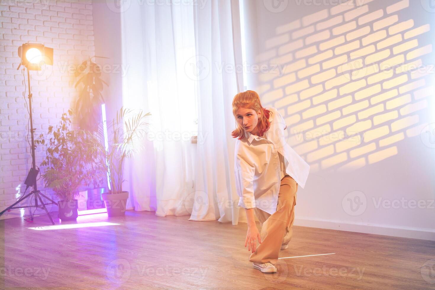 Dancer performing a contemporary routine in a bright studio with creative lighting and serene atmosphere photo