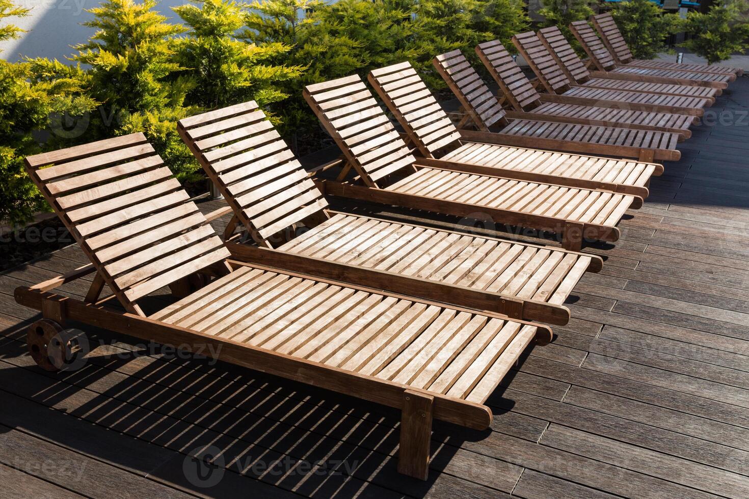 number of empty sunbeds at the pool early in the morning photo