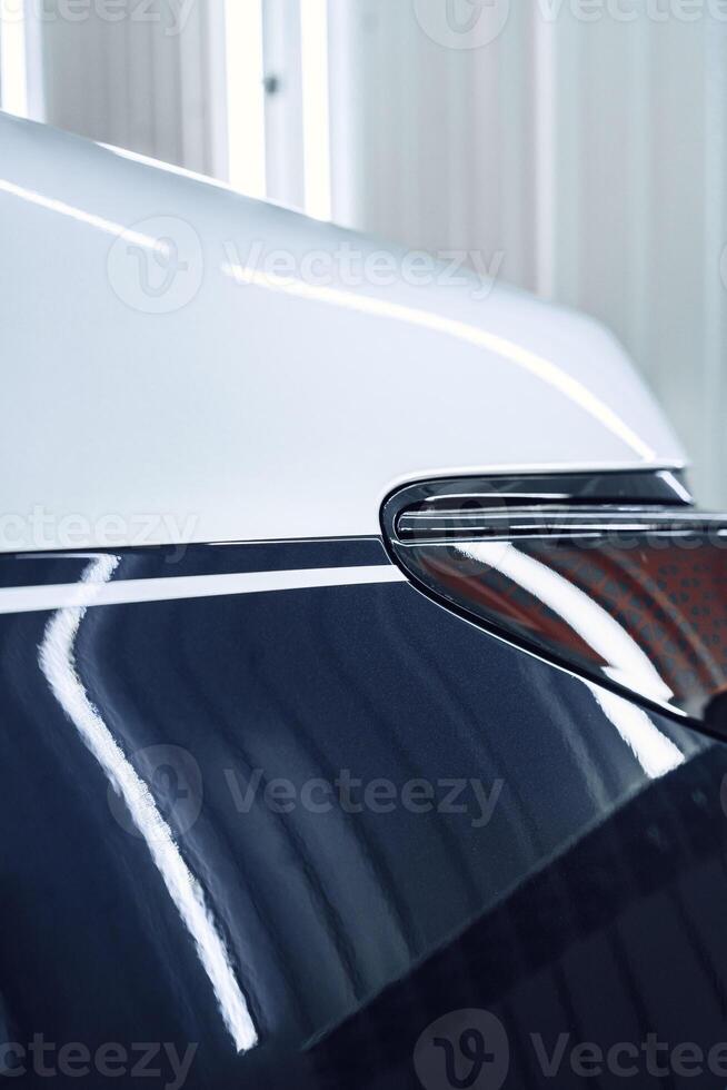 Shiny car detail showcasing sleek lines and reflective surfaces during a professional detailing session photo