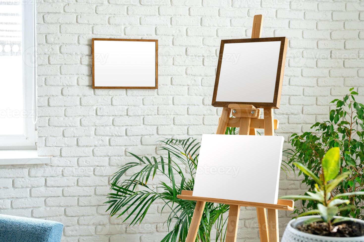 Art studio setup with empty canvas and fresh greenery surrounded by minimalist decor photo