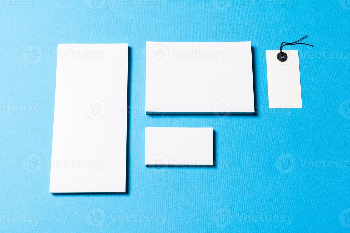 blank office objects organized for company presentation on blue paper background photo