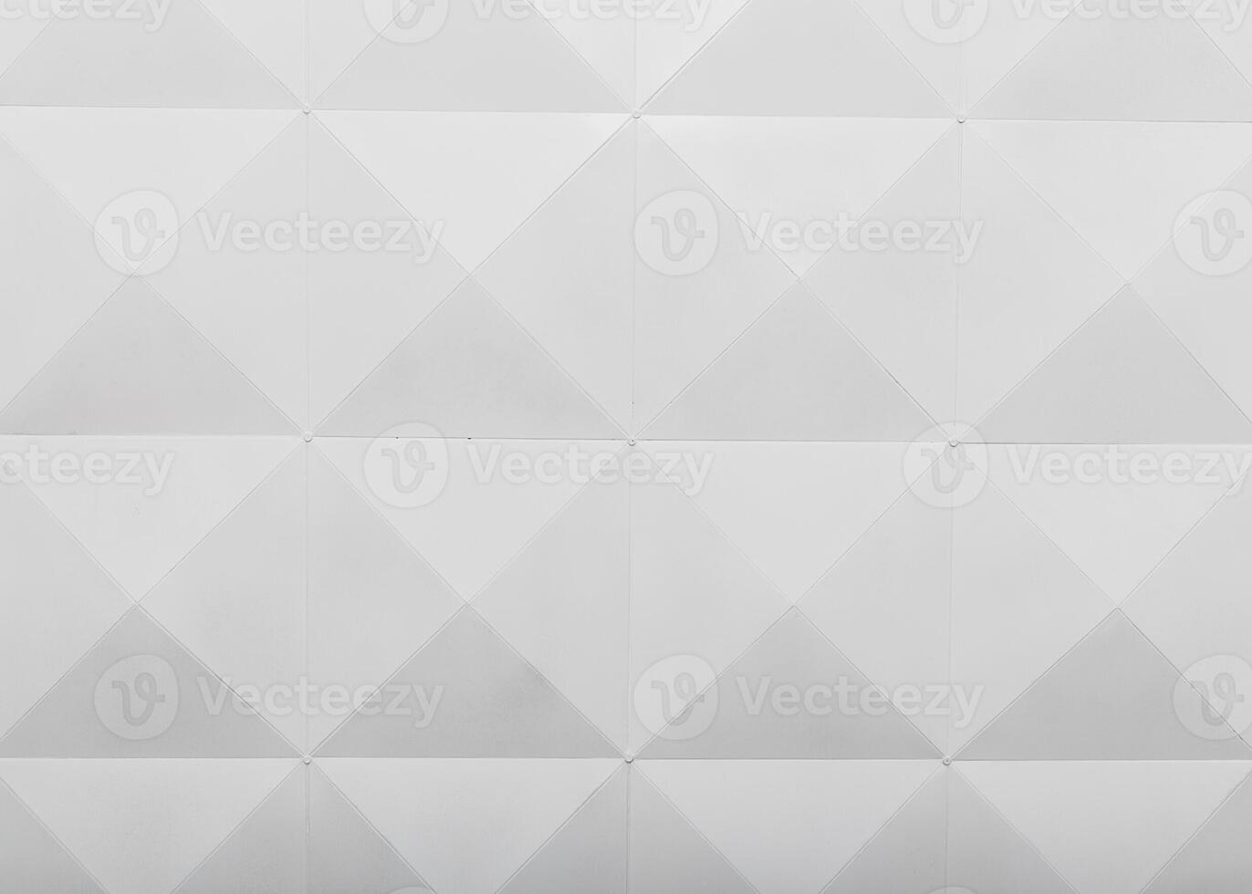 Geometric pattern of white triangular shapes on a textured surface in a contemporary design setting photo