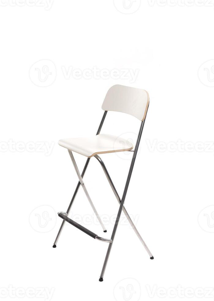 Simple white folding chair stands against a plain backdrop for versatile seating solutions in various settings photo