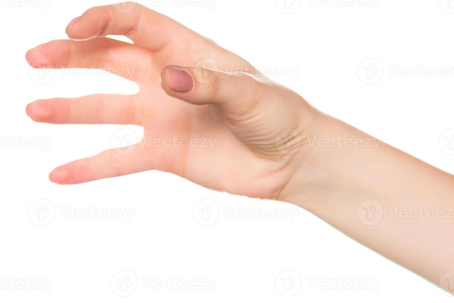 Hand reaching out with five fingers extended near a blank background during daylight photo