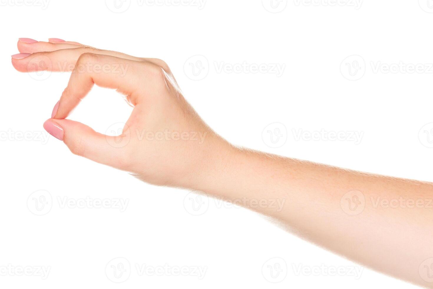 Hand making a circle gesture on a light background during daytime photo