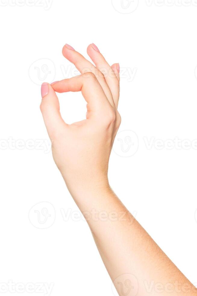 Hand gesture of approval shown with fingers creating an okay sign against a plain background photo