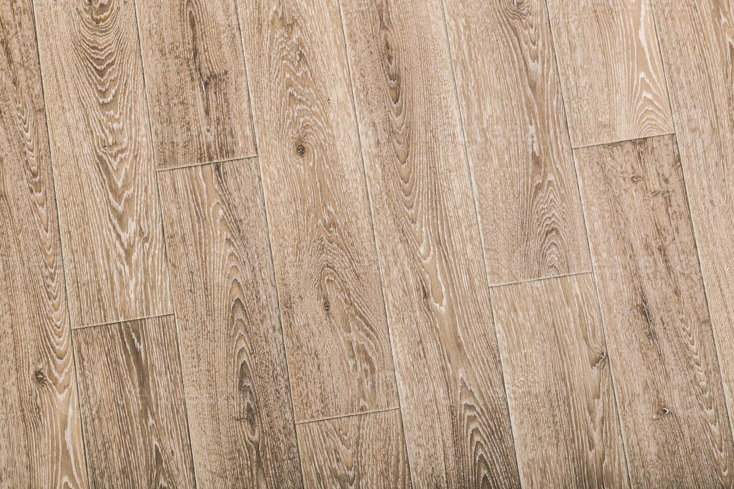 Wooden floor surface with intricate grain pattern in light brown tones, ideal for interior design inspiration photo