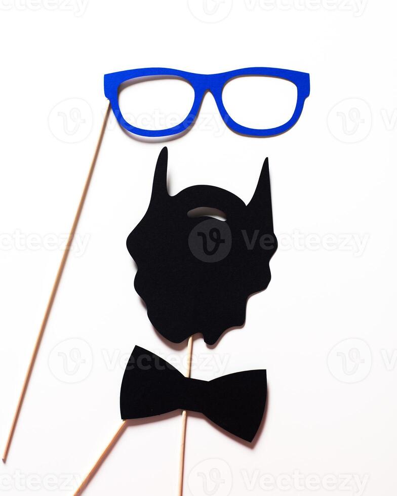 Fun party props displayed together featuring blue glasses, a black beard, and a bow tie for memorable moments photo