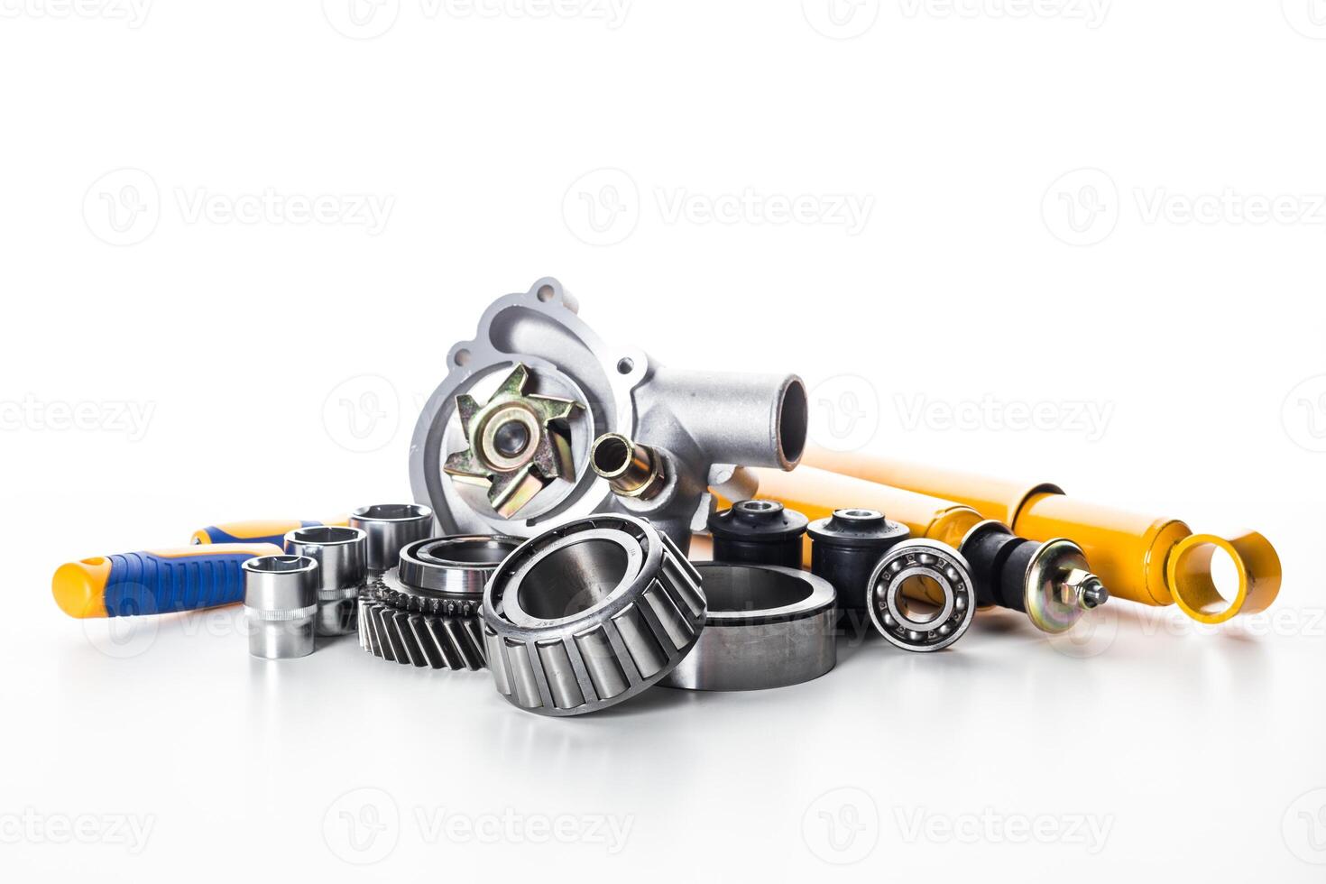 Collection of automotive parts including bearings, pumps, and rods arranged on a white background photo