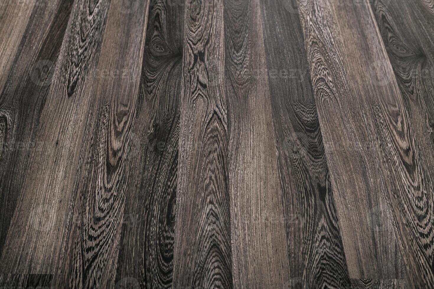 Detailed view of dark wood grain texture with unique patterns and shades in a natural setting photo