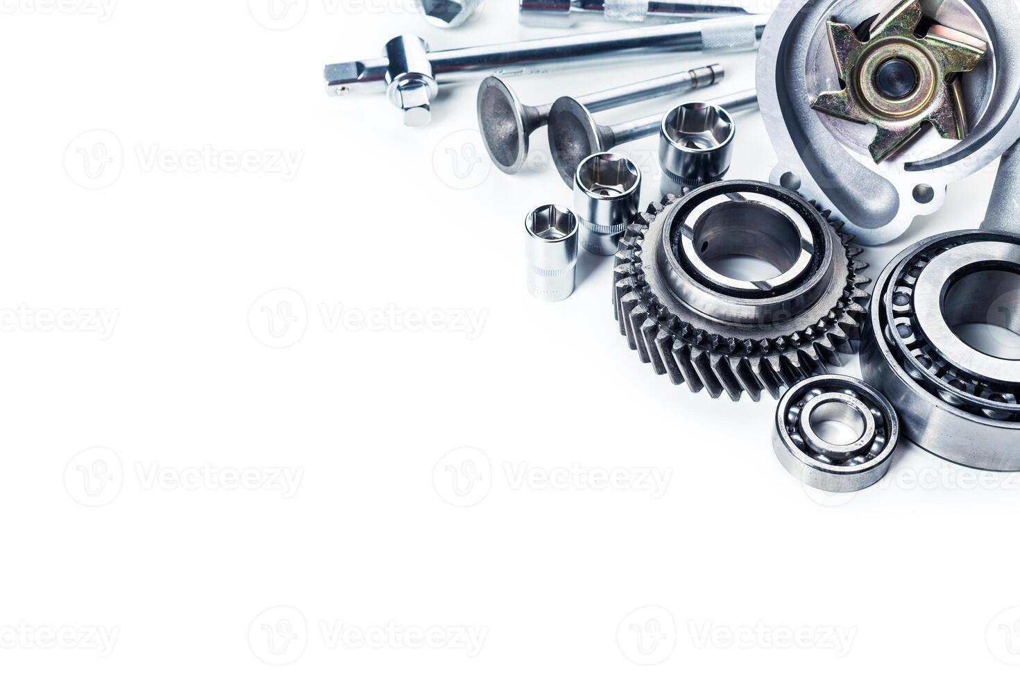 Various mechanical components and tools arranged on a clean surface for industrial purposes photo
