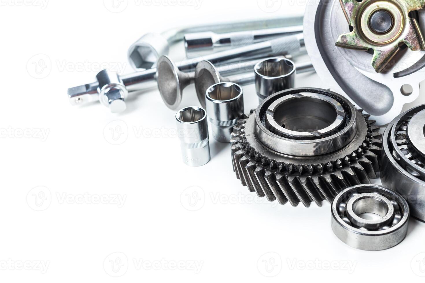 Collection of mechanical components and tools arranged neatly on a white background for repair and maintenance work photo