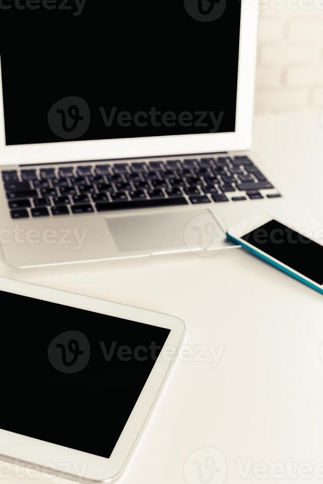 Multiple digital devices on a clean workspace, emphasizing modern technology and connectivity in everyday life photo