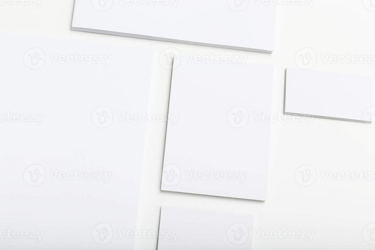 Blank sheets of paper arranged in a creative pattern on a white background during daylight hours photo