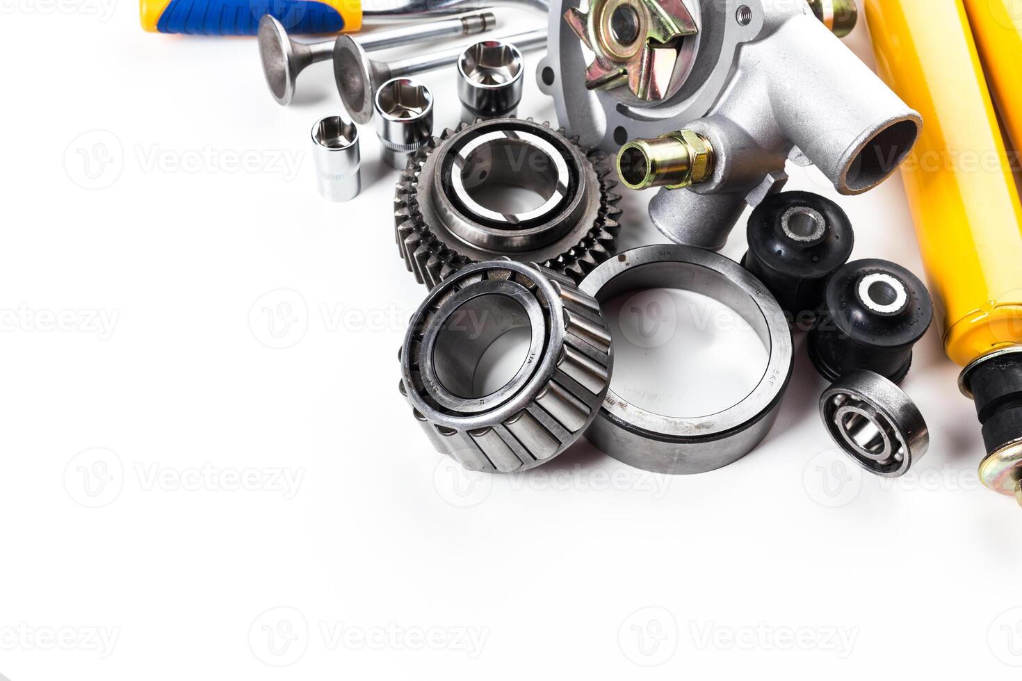 Collection of automotive parts displayed on a clean surface showcasing gears, bearings, and various mechanical components photo