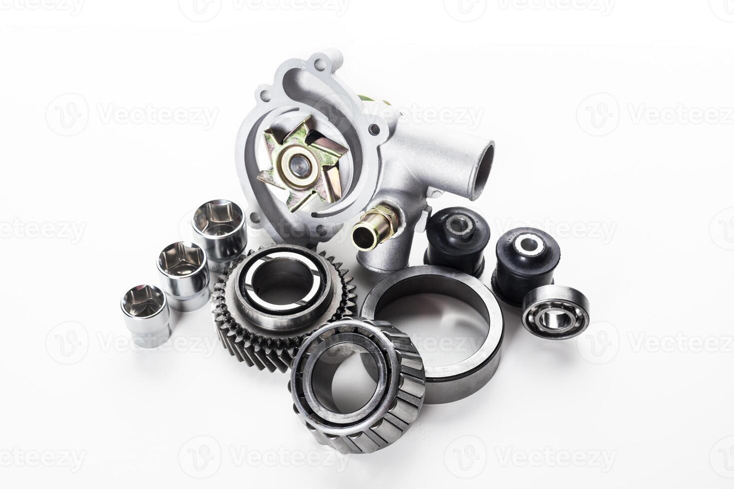Collection of automotive engine parts arranged artistically on a light background showcasing mechanical precision photo