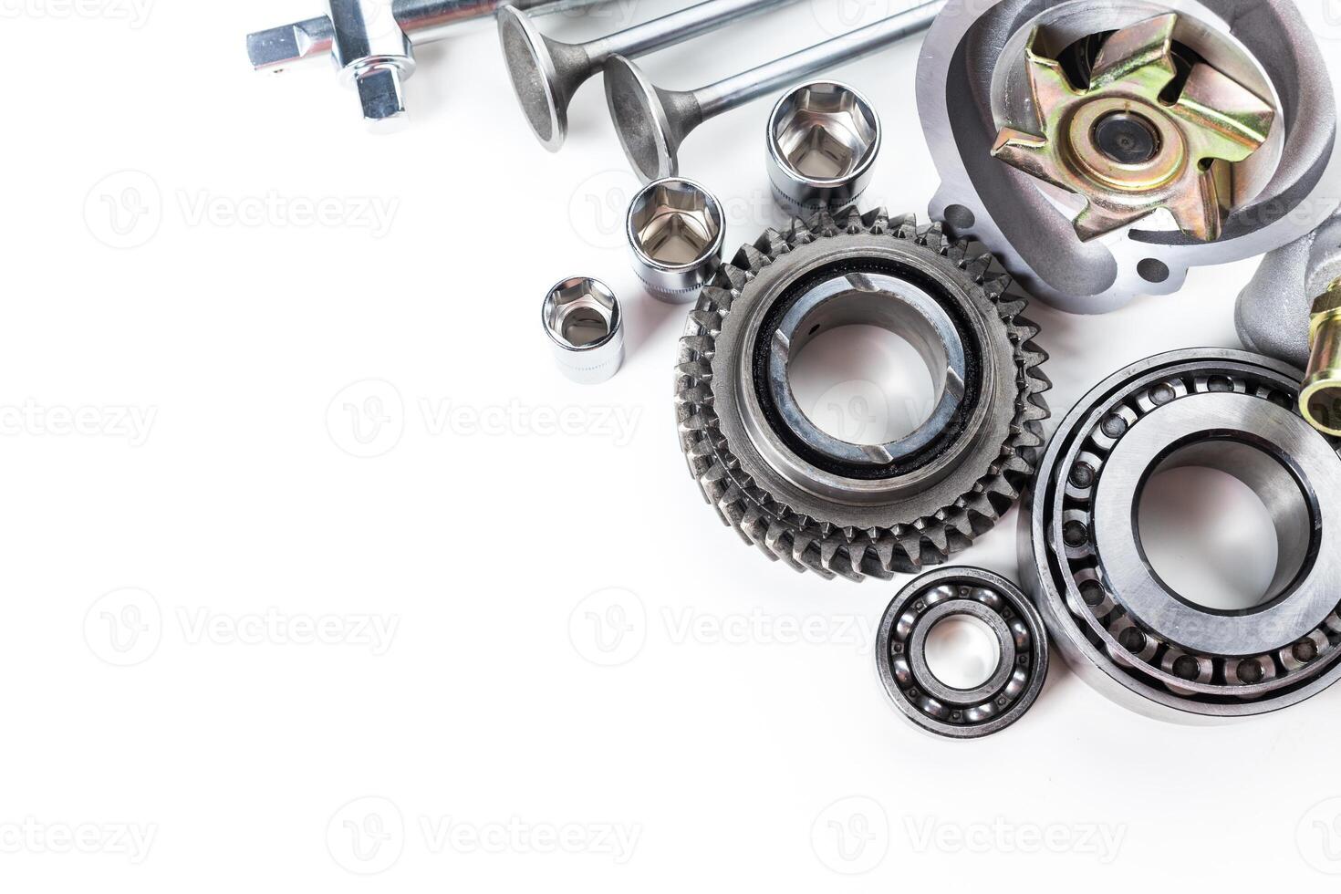 Various Mechanical Parts Arranged Neatly on a White Surface for Assembly and Repair Work photo