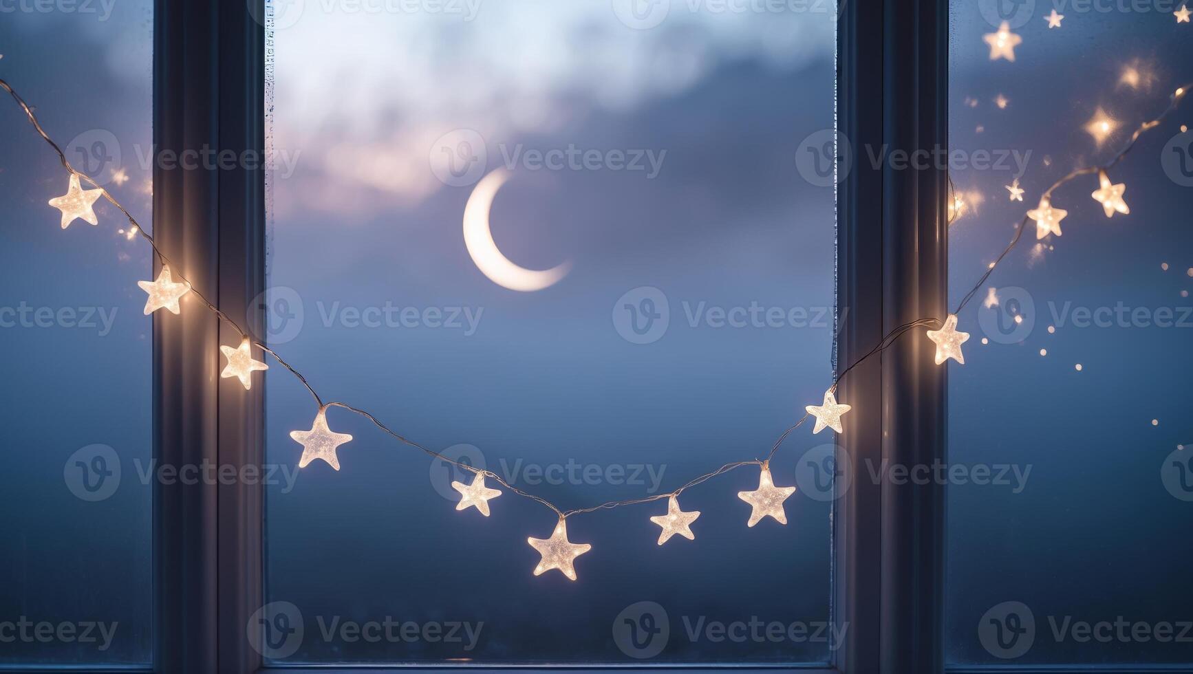 Nighttime view of a crescent moon and glowing star decorations from a window photo
