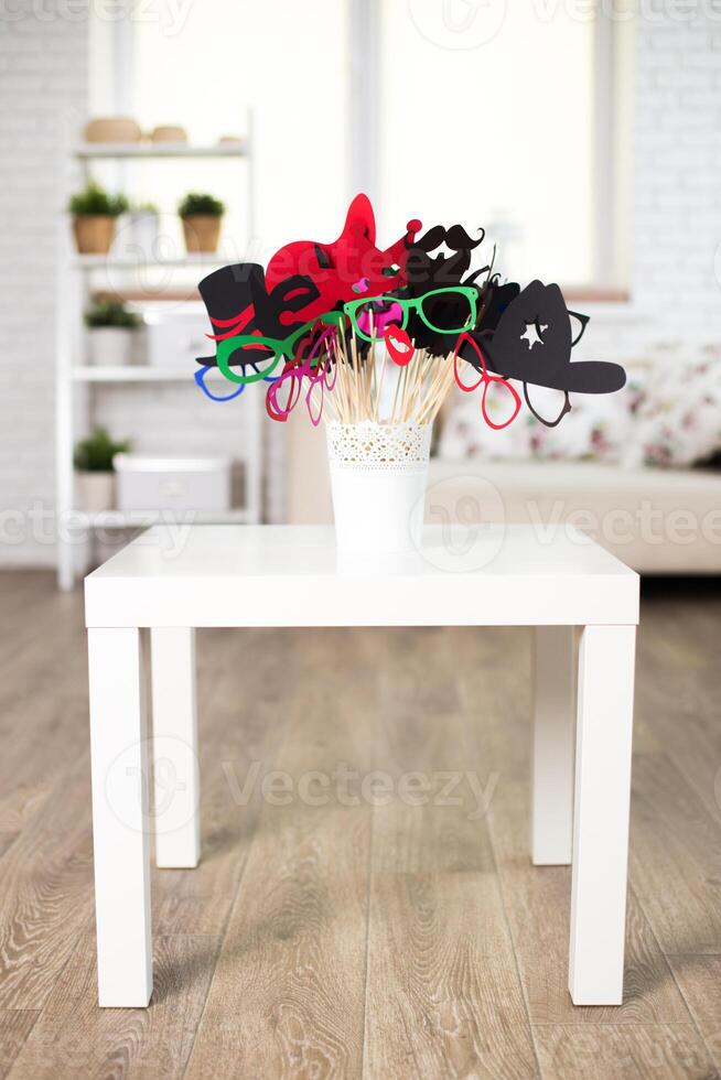 Fun photo booth props displayed in a charming living room setting for gatherings and celebrations