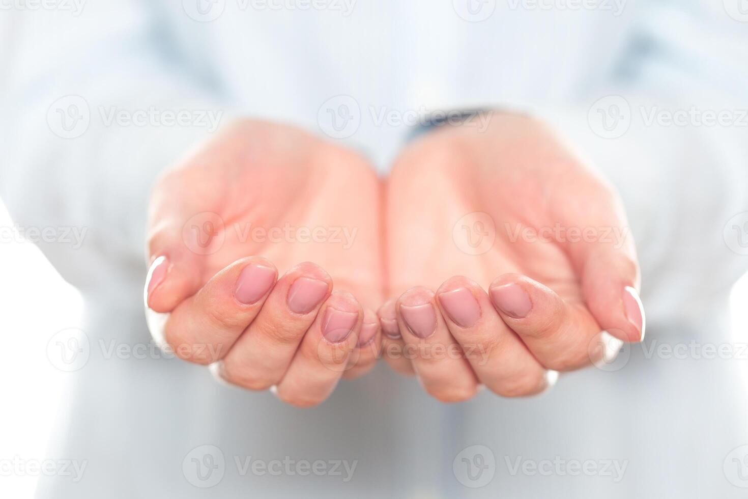 Open hands ready to receive help during a community event in a neutral-colored setting photo