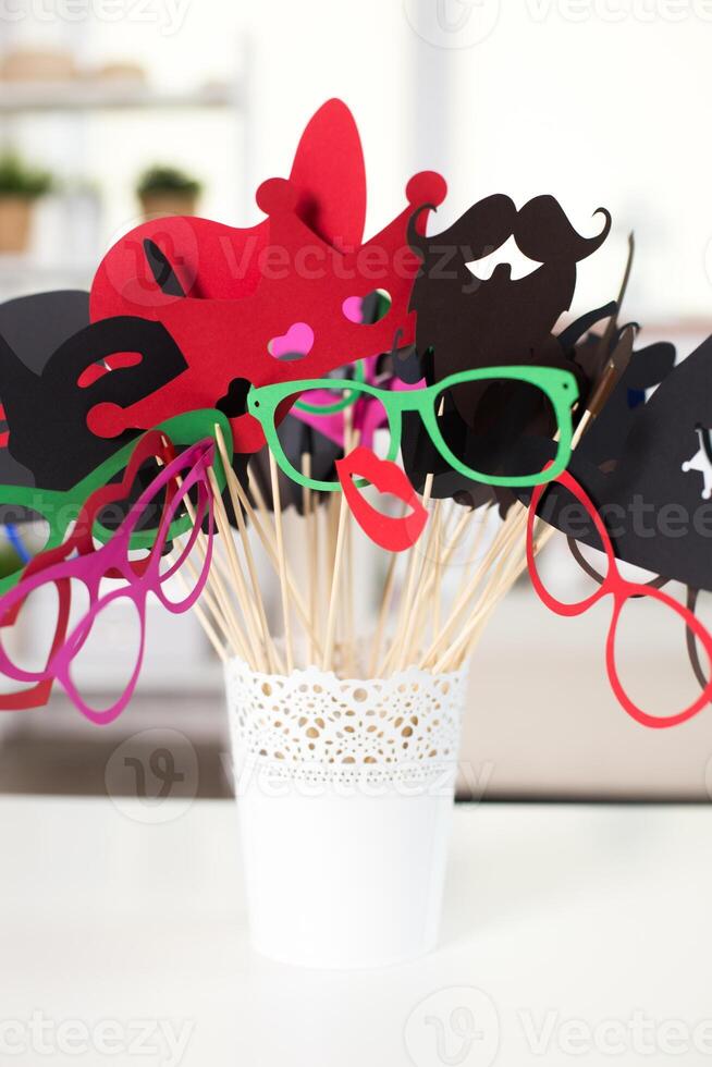 Colorful party props arranged in a white pot for fun celebrations and gatherings photo