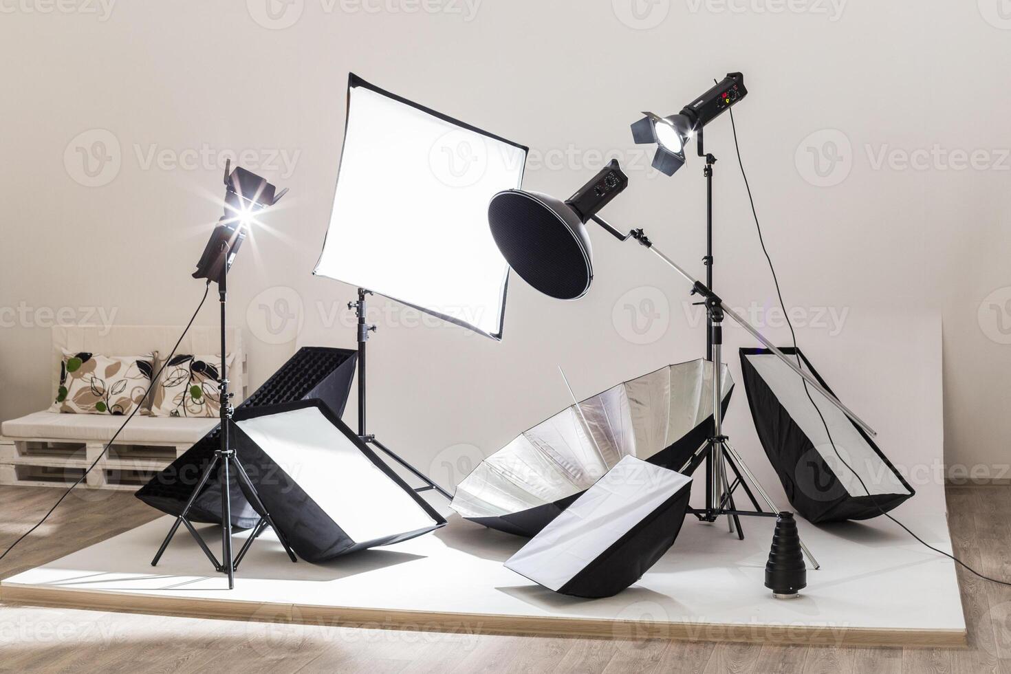 Lighting equipment setup for a photography session in a studio space photo