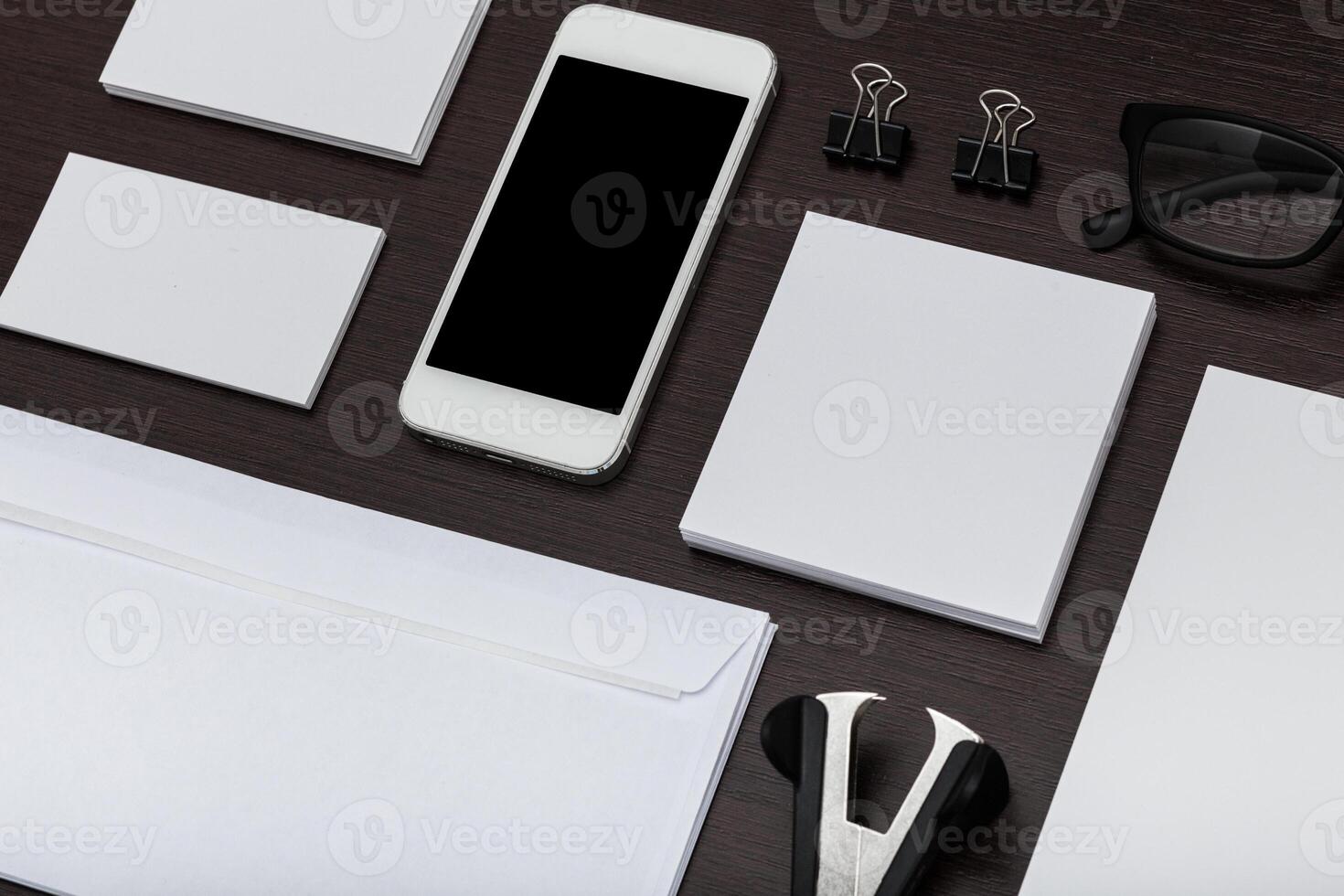 Minimalistic office workspace with stationery and smartphone on wooden desk during daytime photo