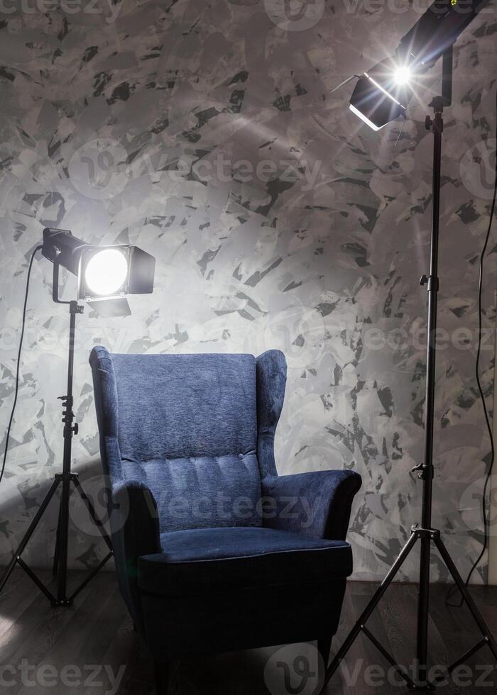 Cozy armchair illuminated by soft lighting in a modern interior setting during evening hours photo