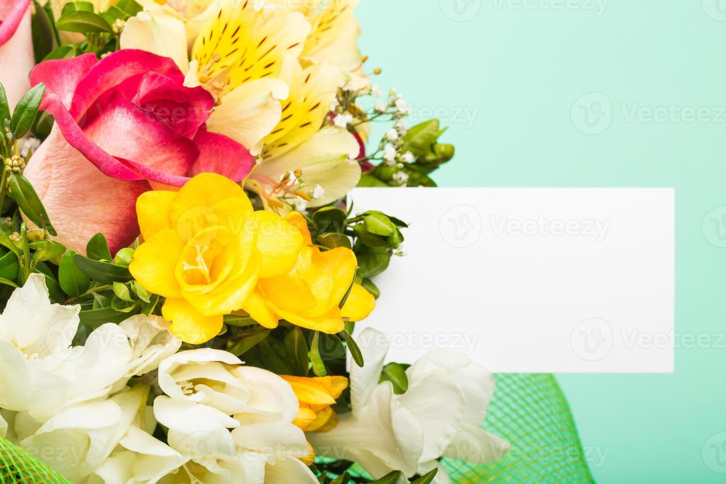 Brightly colored flower bouquet with assorted blooms against a pastel background before an event or celebration photo