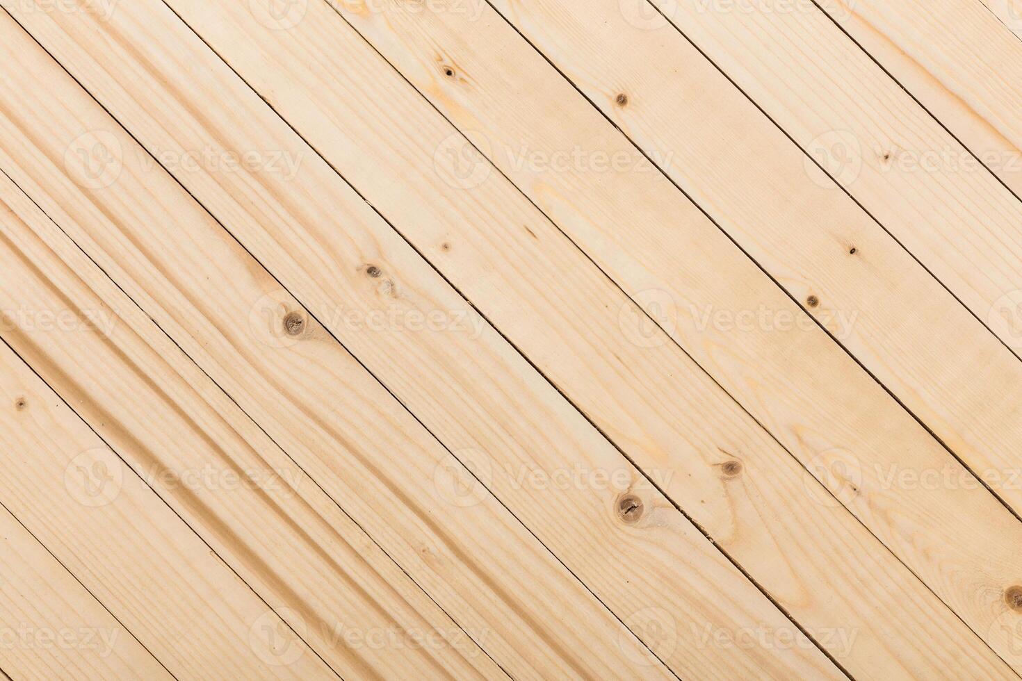 Light wooden floorboards arranged diagonally in a spacious area with natural texture and grain details photo