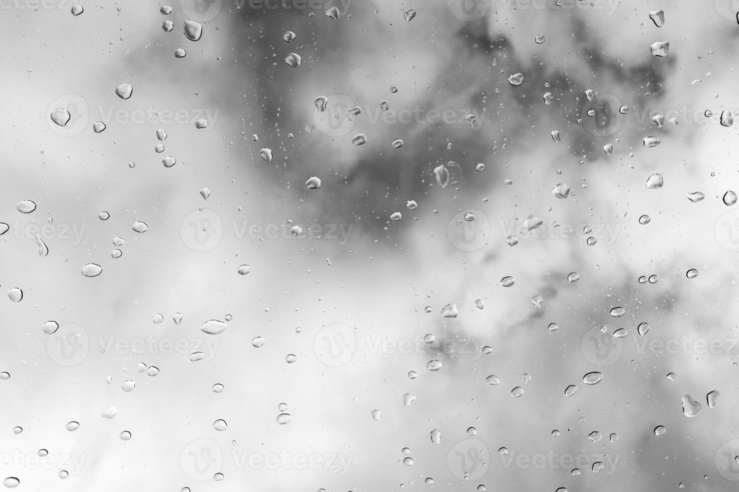 Raindrops on a window create a tranquil atmosphere during an overcast day photo