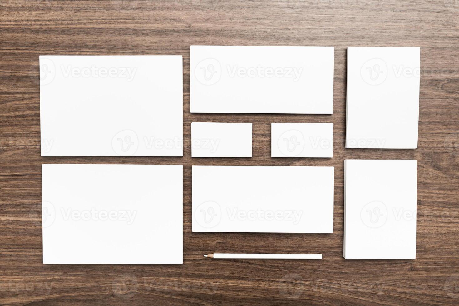Blank stationery arranged on a wooden table for creative design and branding purposes photo