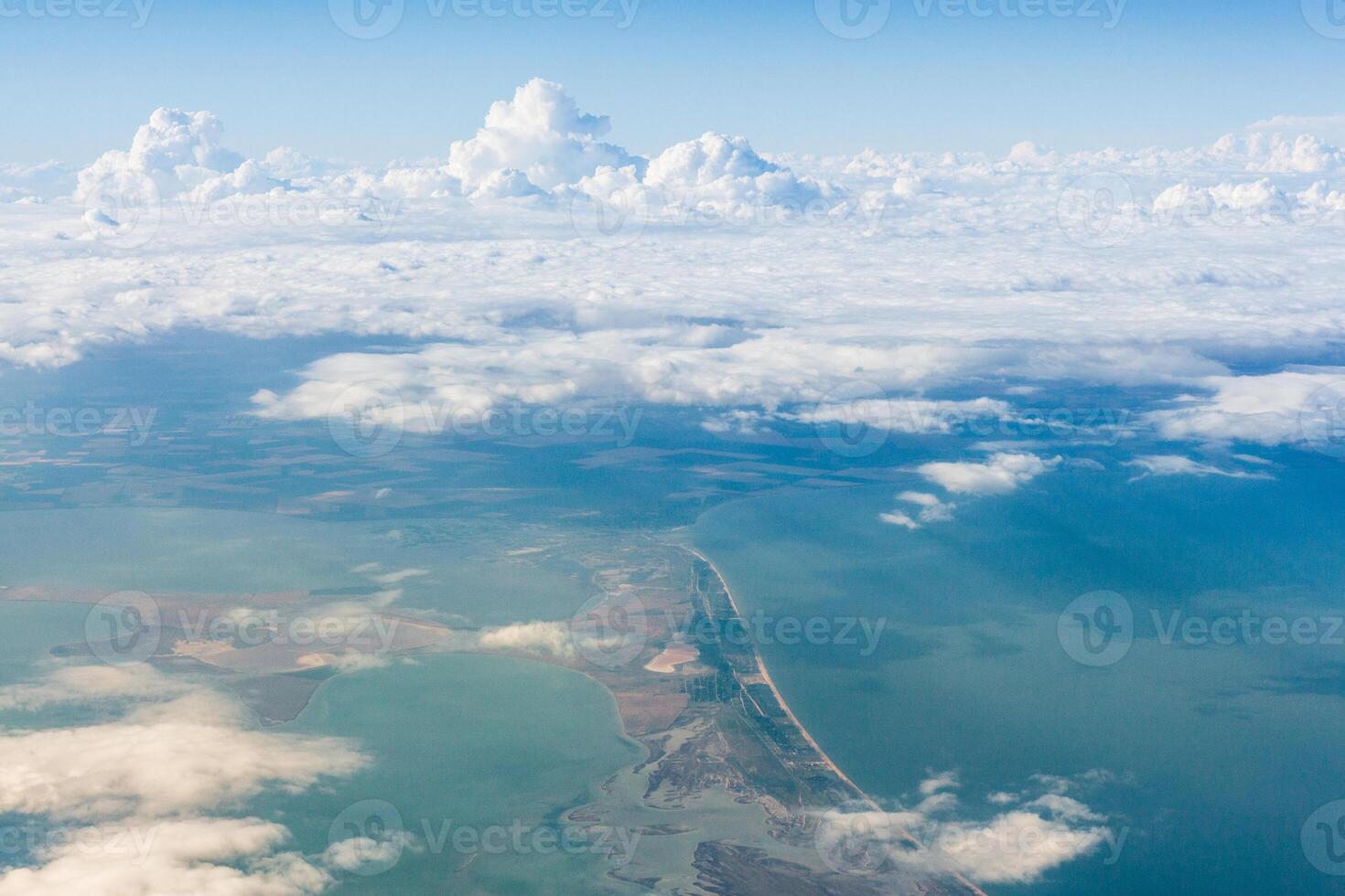 Vast ocean and clouds viewed from above with a stunning horizon at midday photo