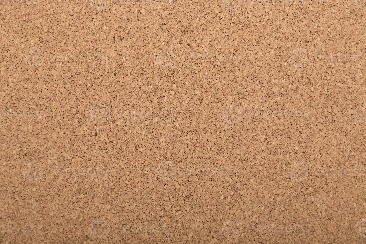 Background of cork board in light tan color used for various display purposes in homes or offices photo