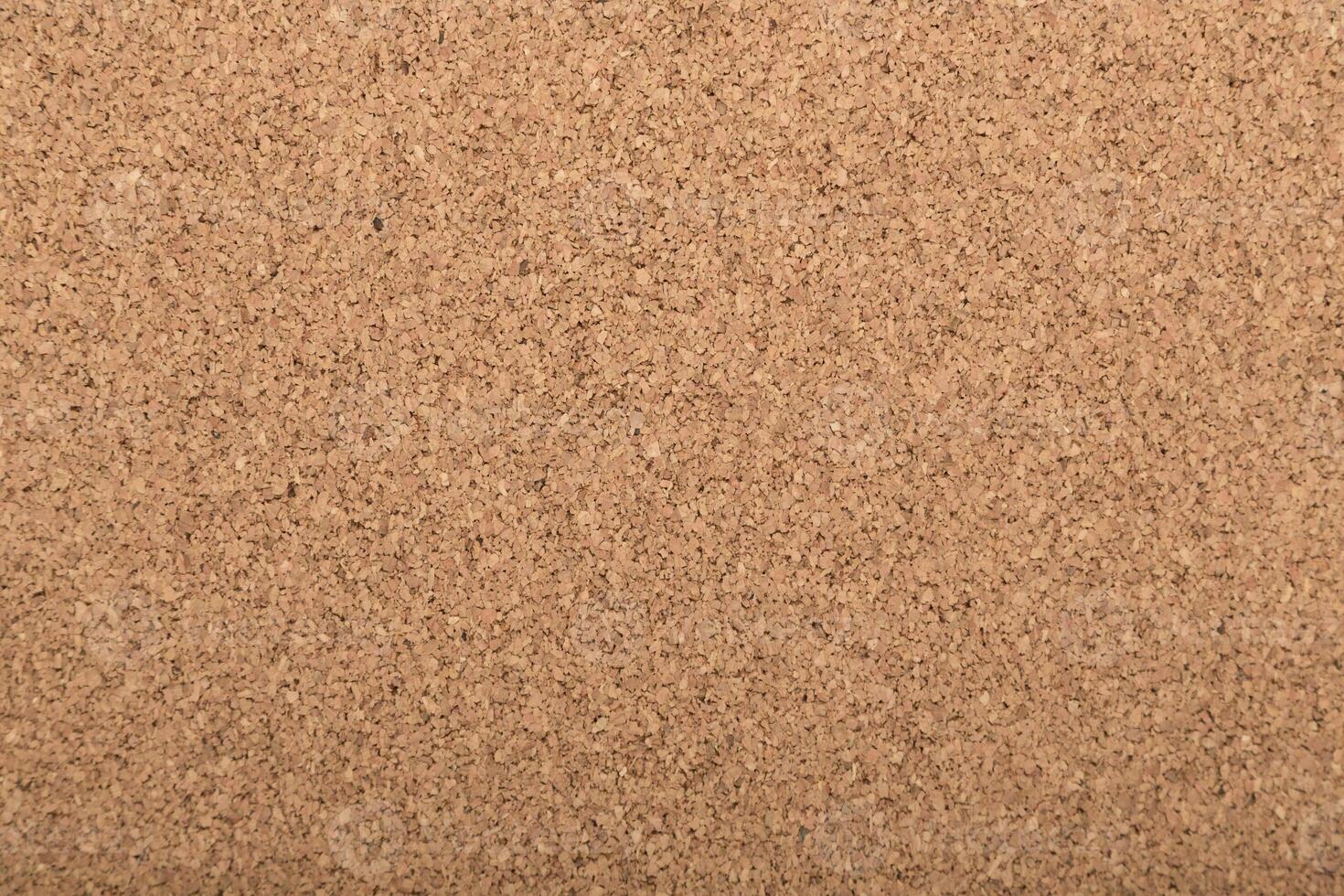 Cork board with a smooth texture in a neutral color, perfect for pinning notes and reminders photo