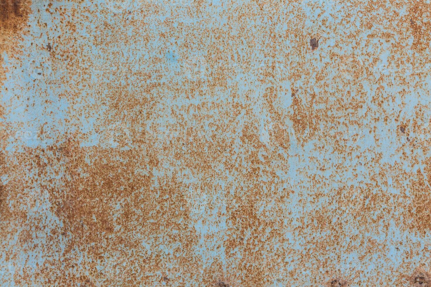 Rusty blue surface showing texture and decay, highlighting years of exposure and wear in an industrial setting photo