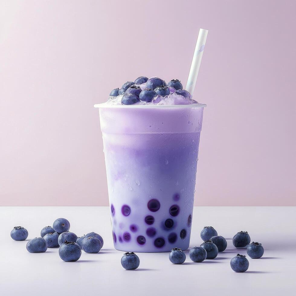 A purple drink with blueberries and a straw photo