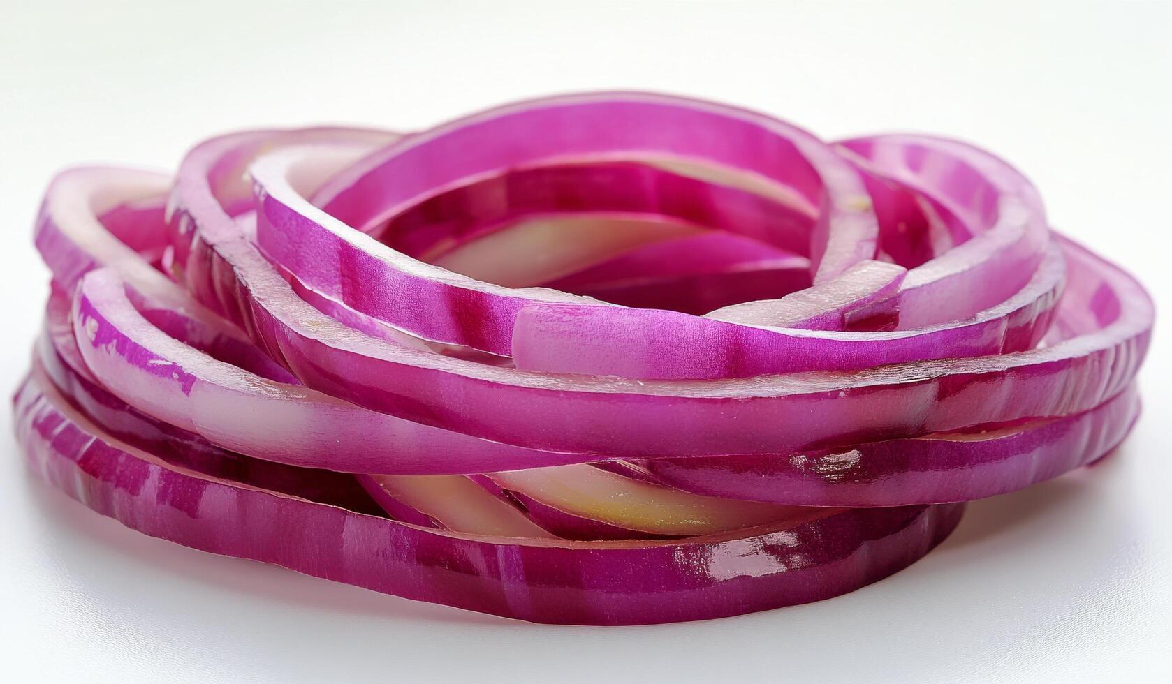 A bunch of red onion slices on a white surface photo