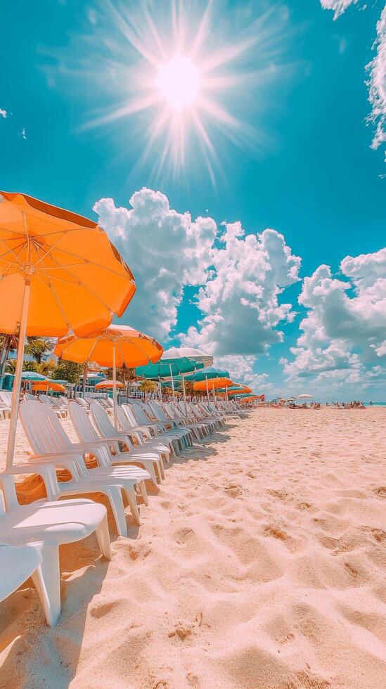 A row of white chairs and orange umbrellas on a beach photo