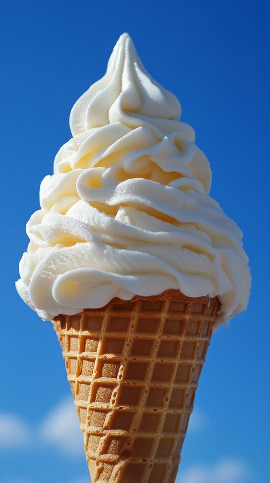 A waffle cone with whipped cream on top photo