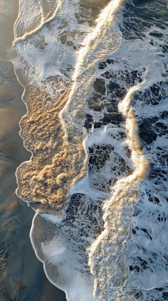 Aerial view of waves crashing on the beach photo
