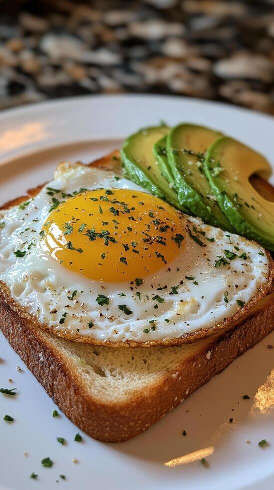 A piece of toast with an egg and avocado photo