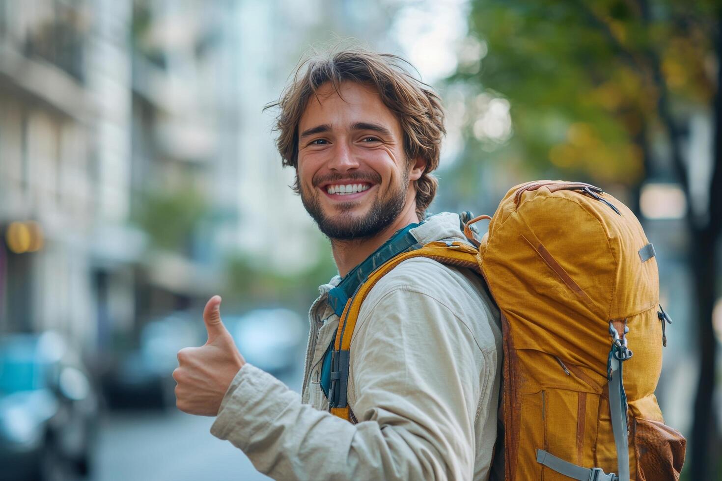 Happy man with backpack showing thumbs up photo
