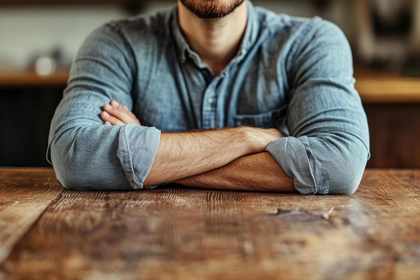 A man sitting at a table with his arms crossed photo
